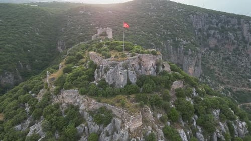 Ancient Hilltop Ruins of Myra Fortress in Lush Green Mountains