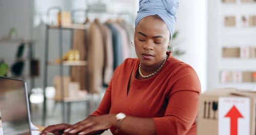 Woman uses Laptop in Modern Workplace with Boxes