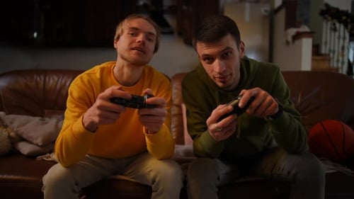 Two Young Men Playing Video Games at Home