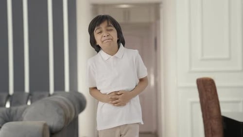 Sick Indian boy having a stomach ache