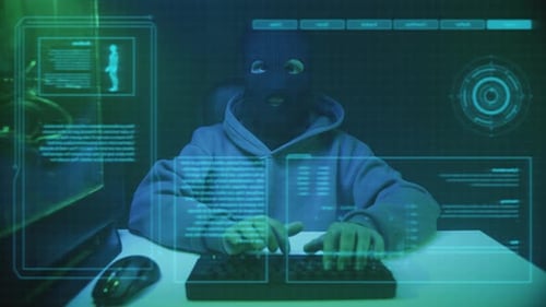 Masked Hacker Working at Computer Station