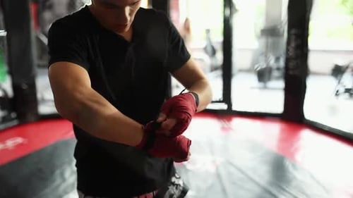 Fighter Wrapping Hands Preparing for Workout