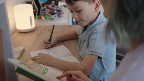 Mother Helping Son with Homework at Home Homeschooling Education Family Support Learning