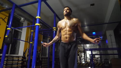 Strong African Athlete with Tattoos Skipping with a Jump Rope at Sport Club Young Black Sporty Man