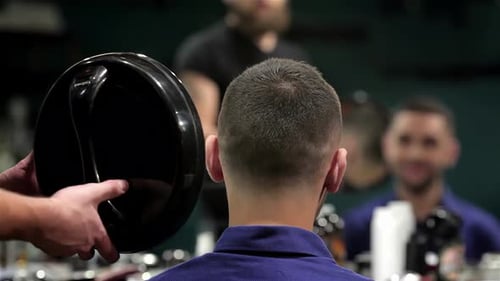 Barber Showing Man Haircut With Mirror