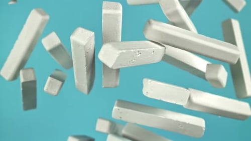 School Chalk Flying on a Blue Background Filmed on a Highspeed Camera at 1000 Fps