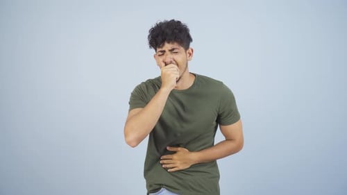 Young Adult Coughing and Holding Stomach in Discomfort
