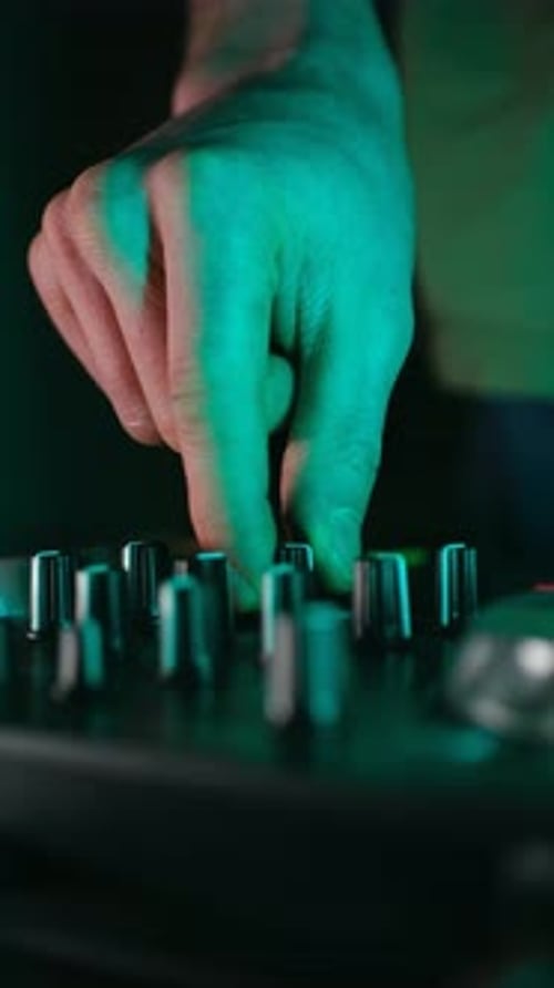 Dj Hand Adjusting Knobs on Sound Mixer
