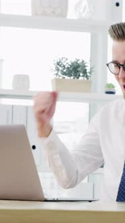 Fist pump, office and business man on laptop for good news, stock trading bonus and success