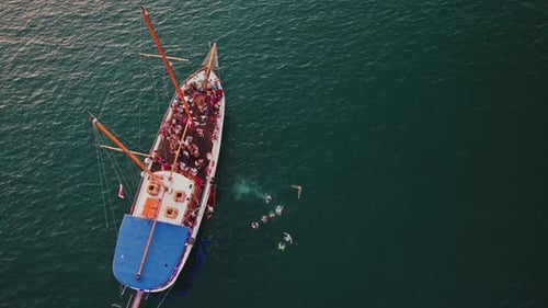 Aerial view of people jumping off the boat in La Valletta, Malta.