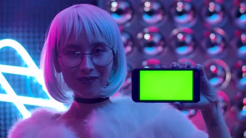 Stylish Young Woman Posing with Green Screen Phone