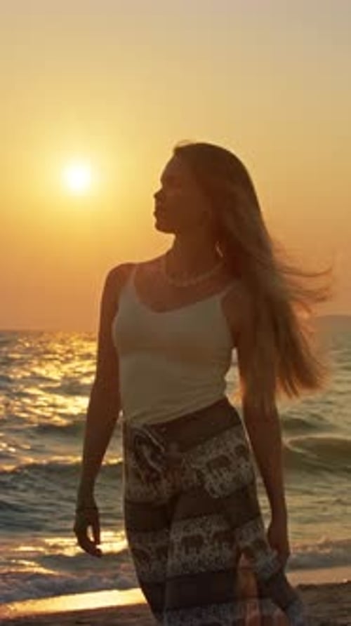 Young woman enjoying sunset at beach