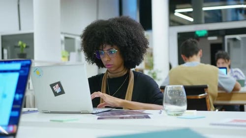 Young Black Woman Working on Laptop in the Office