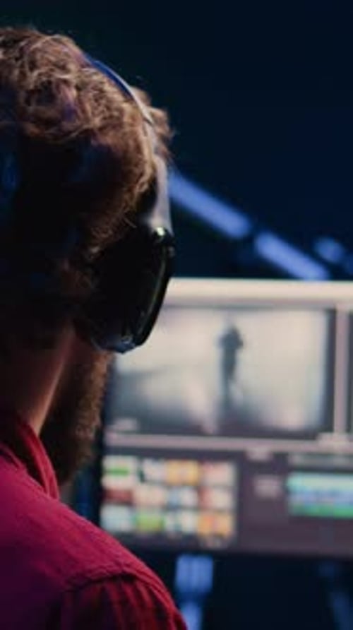 Video Editor Working on Computer at Night