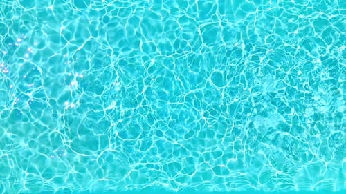 Blue Water in the Swimming Pool with Light Reflections
