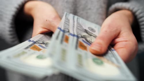 Hands Count Stacks of Hundred Dollar Bills