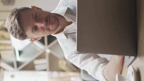 Businessman Sitting and Working in a Cafe Man Using Computer and Devices Business and