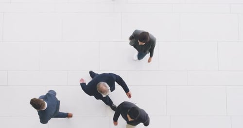 Busy group of business people walking, moving and working in a corporate office from above