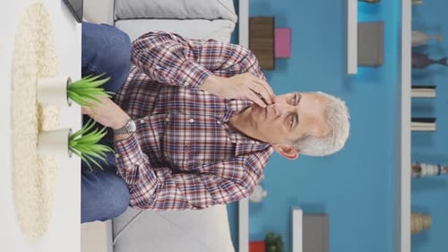 Vertical video of The pessimistic man is confused at home.