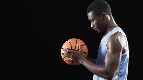 Man Holding Basketball in Side Profile