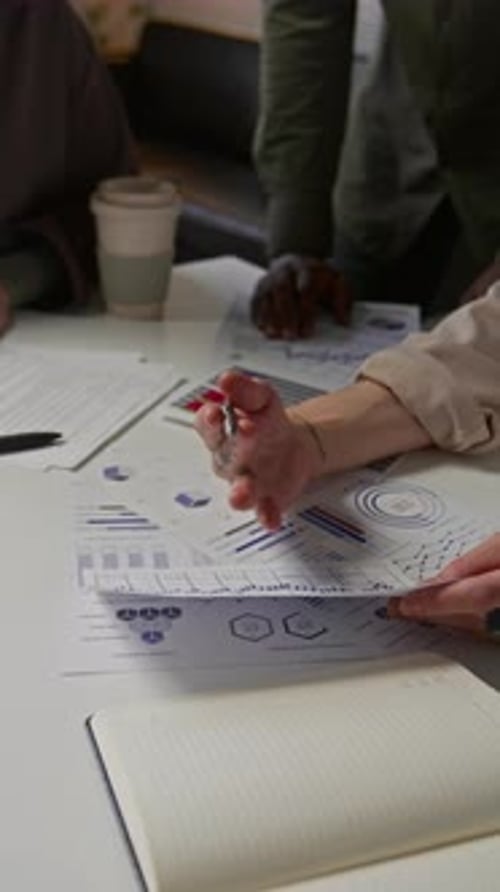 Unrecognizable Young People Working With Charts