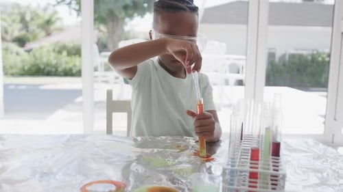 Young Child Performing Science Experiment with Test Tubes