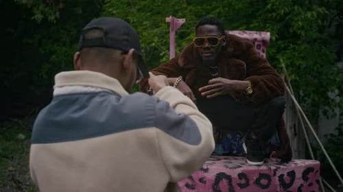 Two Men Talking Outdoors in Fashionable Outfits
