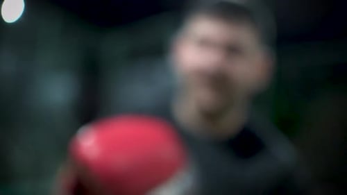 Man Punching with Red Boxing Gloves Close Up