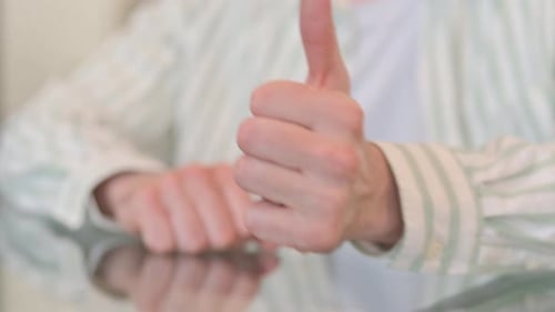 Close of Thumbs Up by Man in Office
