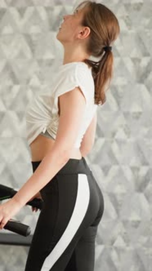 Woman on Treadmill Exercises, Then Touches Up Hair