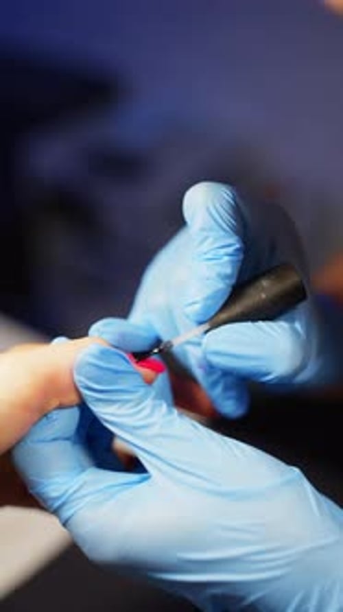 Applying Nail Polish on Fingernail in Beauty Salon