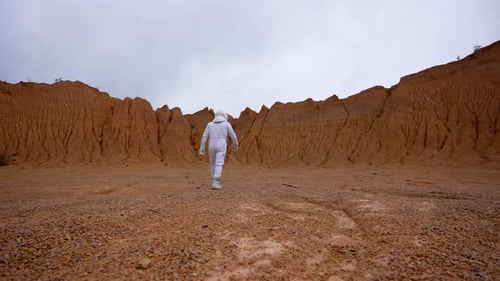 Astronaut Walks on the Surface of Mars to the Boundary of the Crater