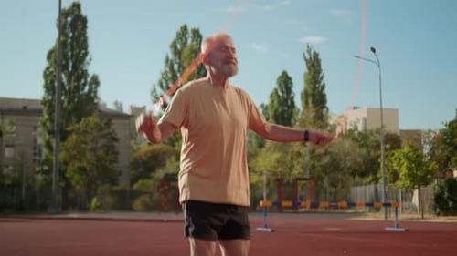 Senior Man Jumps Rope for Fitness Outdoors