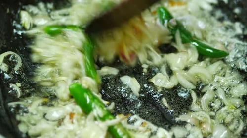 Frying Diced Onions and Peppers in Pan
