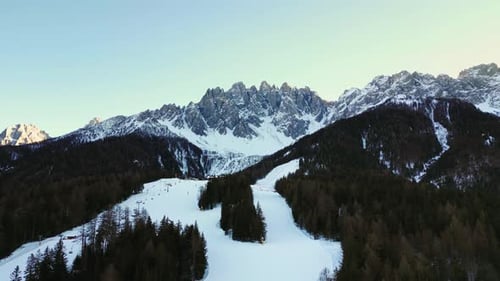 Aerial view of ski slope and mountains, Italy.
