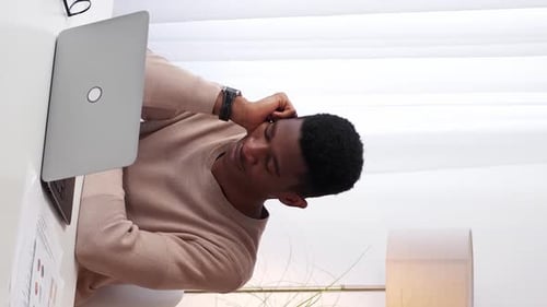 Young Adult on Phone Working at Desk at Home