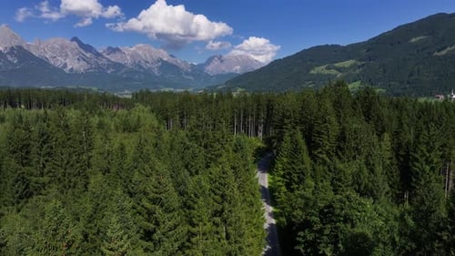 Scenic Drone Footage Capturing Forest Paths Among Rugged Mountain Peaks