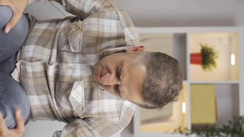 Vertical video of The man is suffering from joint pain.