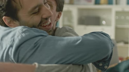 Affectionate Men Embracing and Smiling at Each Other