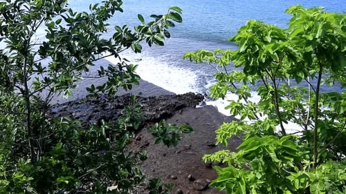 Tropical Ocean Waves Crashing on Rocky Shore
