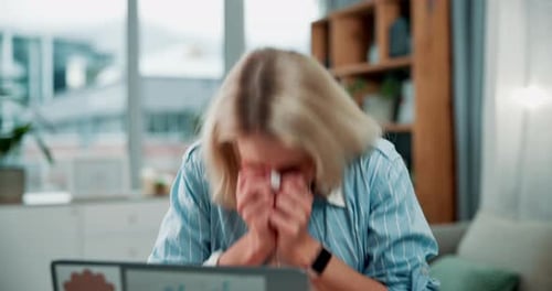Woman Blowing Nose with Tissue in Living Room