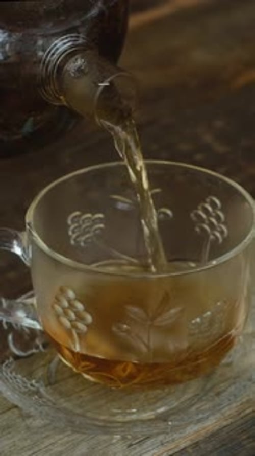 Vertical Video Preparing Tea Pouring Tea Into Mug