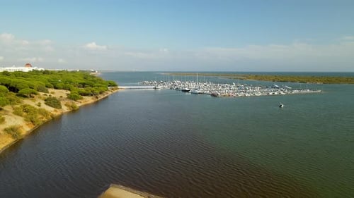 Aerial drone takeoff over docks with many yachts at Piedras river, Puerto Marina El Rompido, Spain