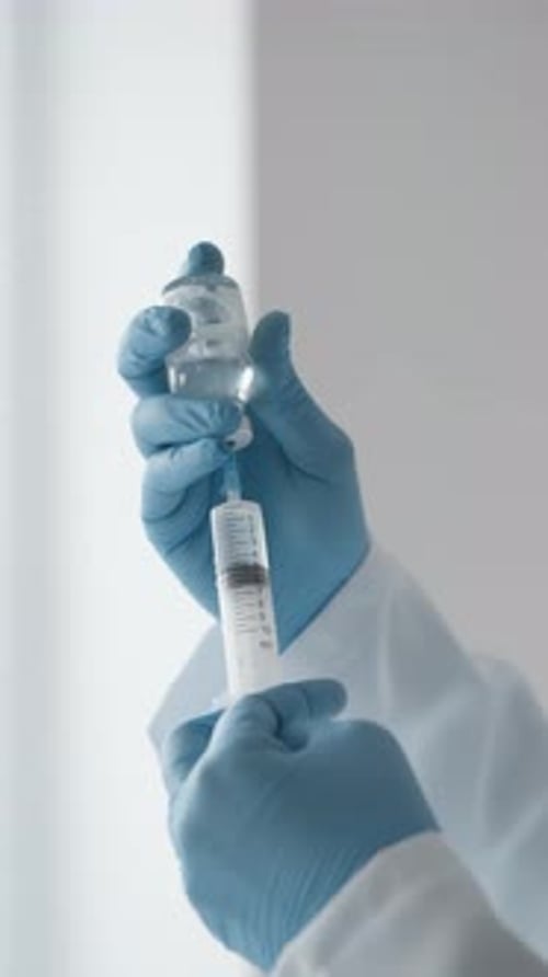 The Doctor Carefully Selects the Dose of the Drug in the Syringe Showing Technical Skill and a High