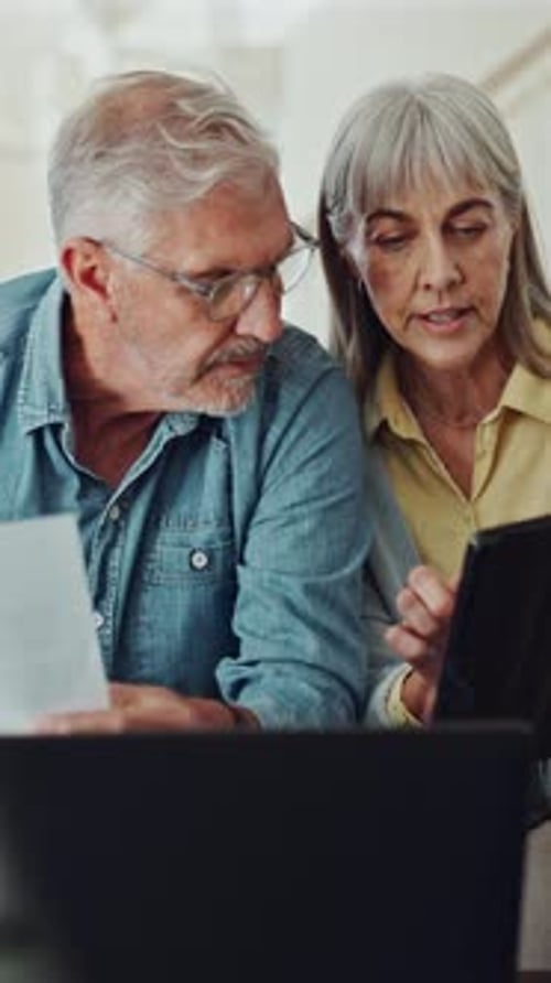 Senior couple, laptop and finance documents on sofa, review or planning for pension at apartment