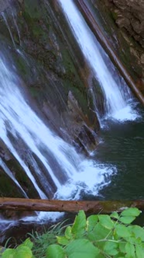 A Serene Waterfall Gracefully Cascading Into a Crystal Clear Refreshing Pool of Water