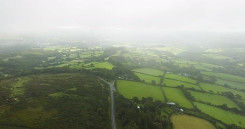 Quiet Country Road Leading Through Rolling Hills Of Dartmoor Aerial View