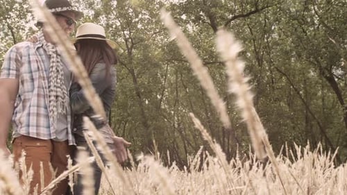 Casually Dressed Heterosexual in Love Couple Having Fun Together in Field. Steadicam