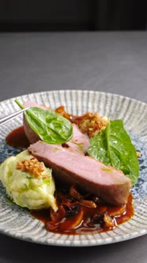 Final Touch in Dish Serving Cooking Process Luxury Restaurant Chef Finishing Duck Dish with Salad