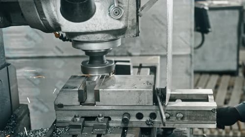 Industrial Machine Cutting Metal with Flying Sparks